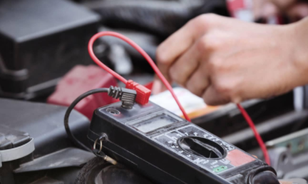 a person checking car battery