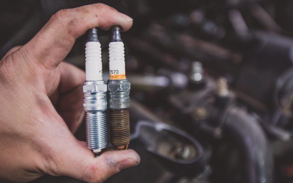 a person holding spark plug