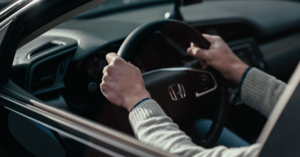 a person holding the steering wheel