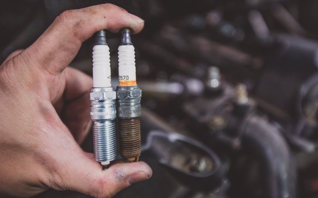 a person holding a spark plug