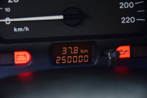 5 Car Maintenance Tips for High Mileage Vehicles | ABS Unlimited in Fairfax, VA. Image of an odometer showing high 200,000 mileage of a car.