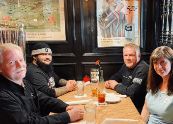 image of ABS owners and 2 male mechanics at dinner together at local restaurant